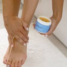 Applying ointment to feet - Nourishing care for diabetic and circulatory health.