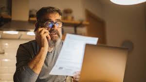 Man talking on the telephone and reading a document