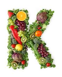 Assorted fruits and vegetables forming the letter K - showcasing the diverse sources of Vitamin K in nature.