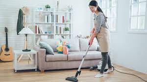 Woman vacuuming home to reduce allergens. Allergy proof cleaning for a healthier living space.