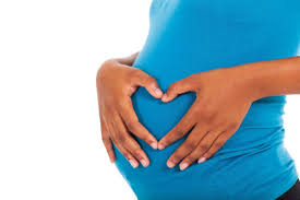 Pregnant woman embracing a healthy diet while joyfully bonding with her baby, promoting wellness for both mother and child.