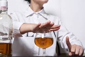 Choosing Sobriety: Image of a Hand Over a Glass of Alcohol. Minimizing Excessive Alcohol Consumption