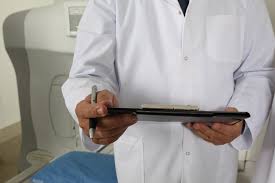 Medical professional holding tablet and pen 