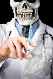  Physician holding syringe in eerie skull mask