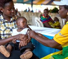 Child seated on their mother's lap, calmly receiving a vaccine administered by a healthcare professional, emphasizing the importance of gentle care during the immunization process.