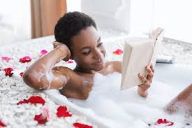 Woman taking a relaxing bath while reading a book. Indulge in self-care for a mentally refreshing experience of relaxation and enjoyment.