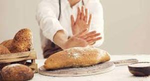 Image of a person declining bread, emphasizing a gluten-free lifestyle.