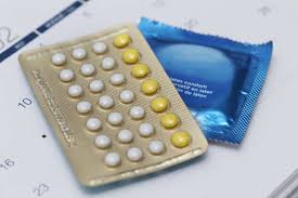 Image showcasing a sample of essential contraceptive items – a packet of condoms and contraceptive pills, representing two popular and accessible methods for individuals seeking reliable contraception options.