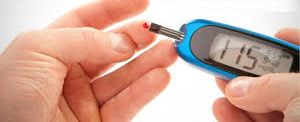 Image of a person using a glucometer to check their blood sugar level, an essential step in managing diabetes.