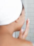 woman applying skin care product for radiant skin