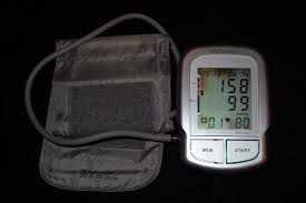 Automatic blood pressure machine displaying hypertension reading: 158/99mmHg and pulse 80. Learn about managing high blood pressure for better health.