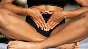 Woman performing Kegel exercises seated, emphasizing pelvic floor muscle engagement.