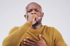 Respiratory Health: Person demonstrating a cough, highlighting the importance of lung care.